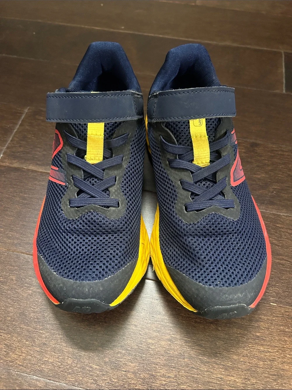 New Balance Kids Navy Sneakers with Yellow & Red Accents